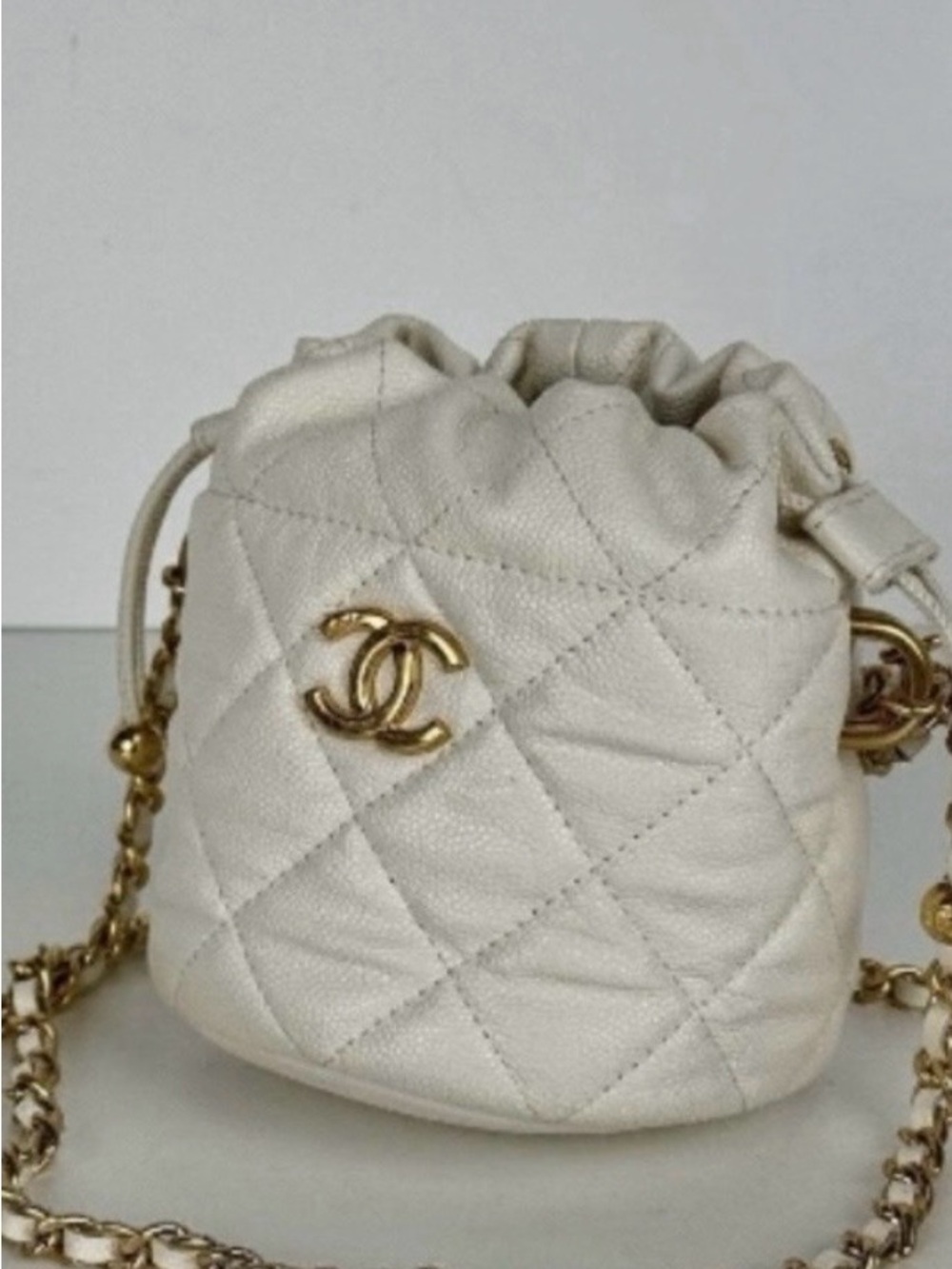 CHANEL Quilted Mini Drawstring Bucket Bag in Cream with Gold Hardware